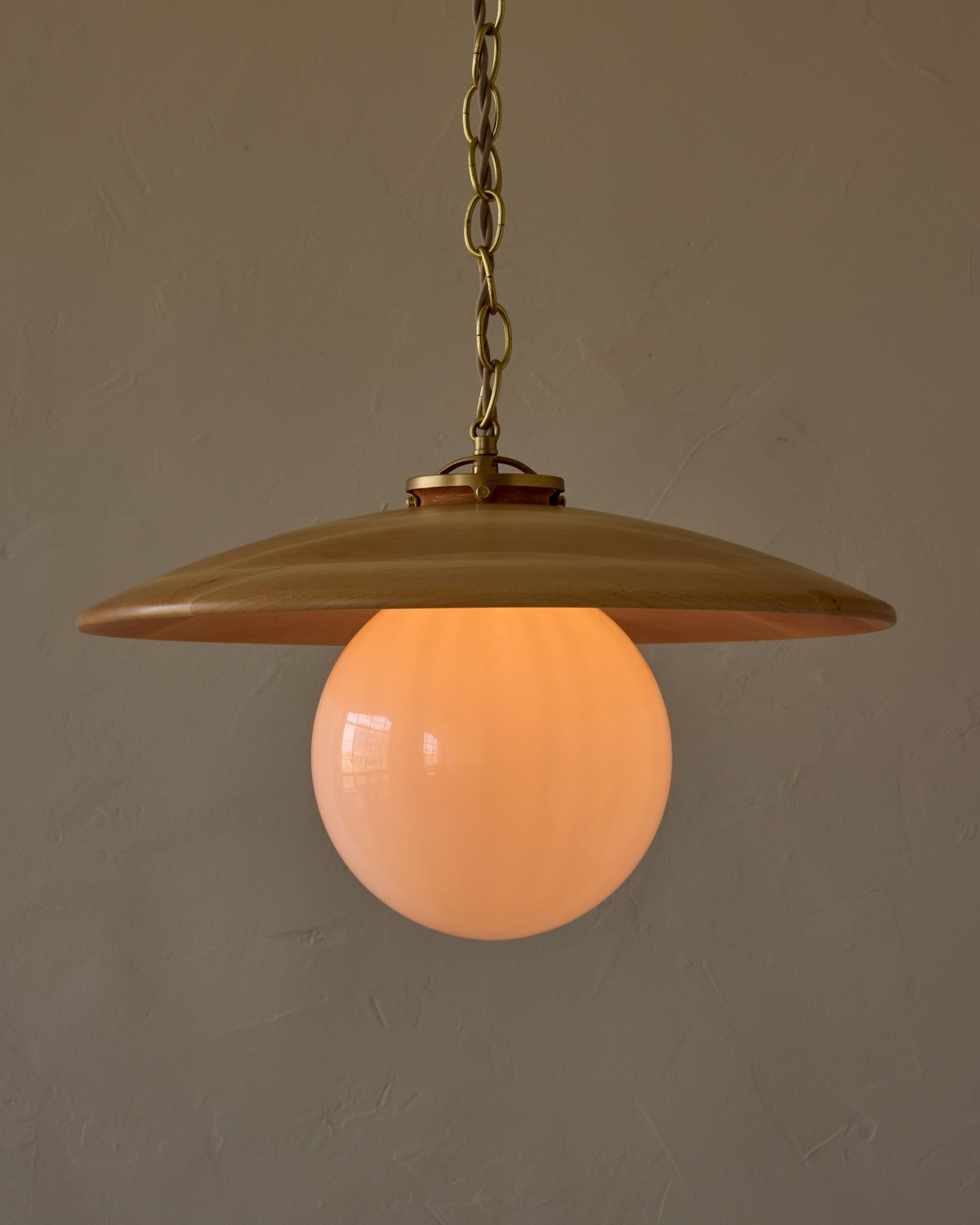 Large pendant light with oversized clear glass globe and decorative wooden clear maple shade with brass chain #shade-finish_natural maple #globe_white glass #cord-color_beige