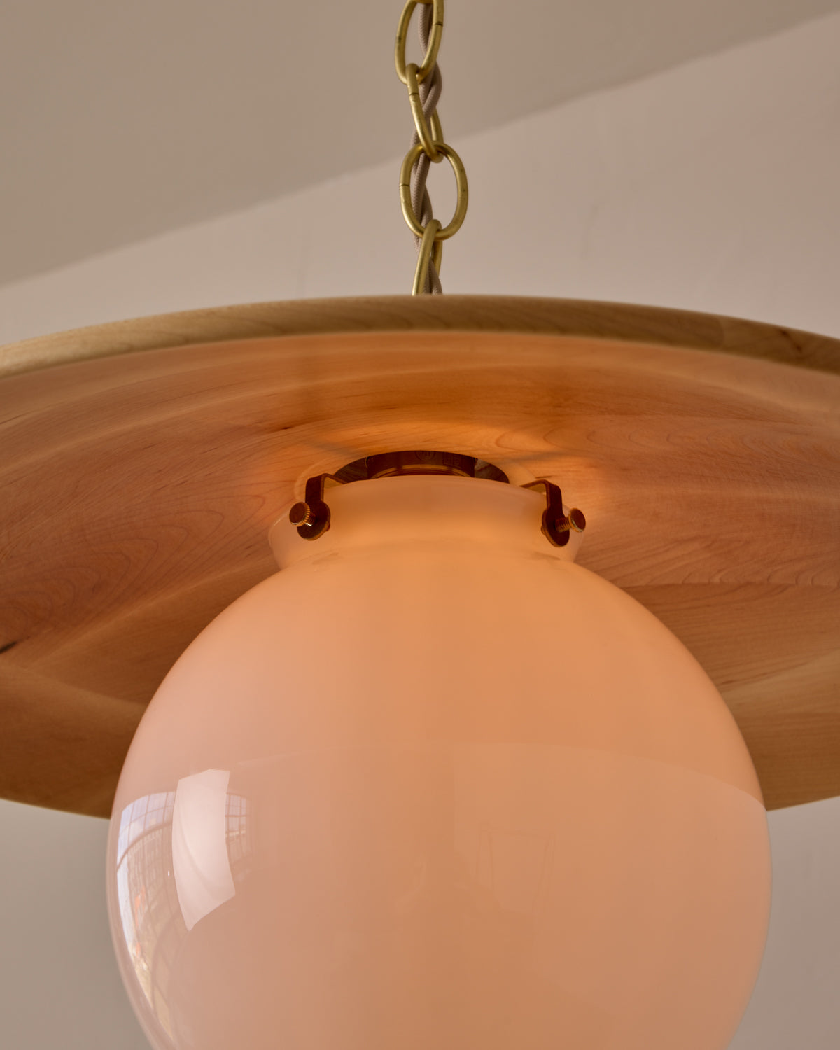 Large pendant light with oversized clear glass globe and decorative wooden clear maple shade with brass chain #shade-finish_natural maple #globe_white glass #cord-color_beige