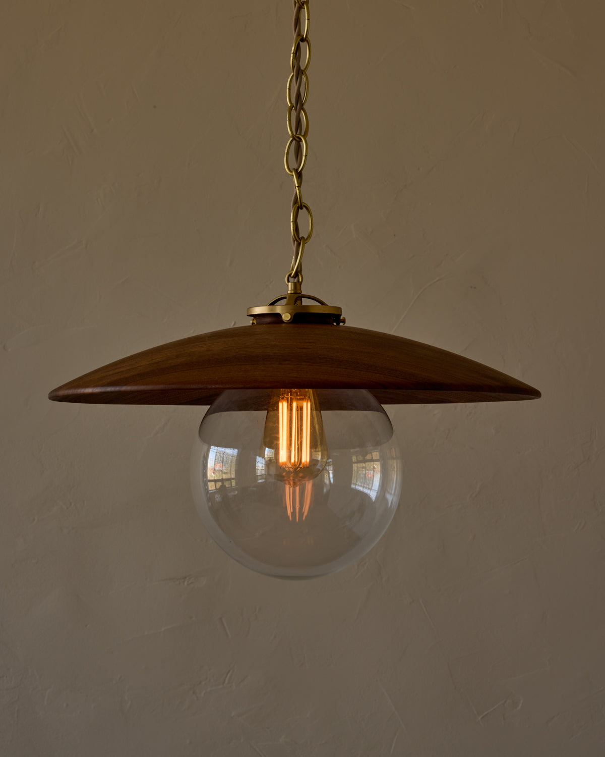 Large pendant light with oversized clear glass globe and decorative wooden clear maple shade with brass chain #shade-finish_black walnut #globe_clear glass #cord-color_beige