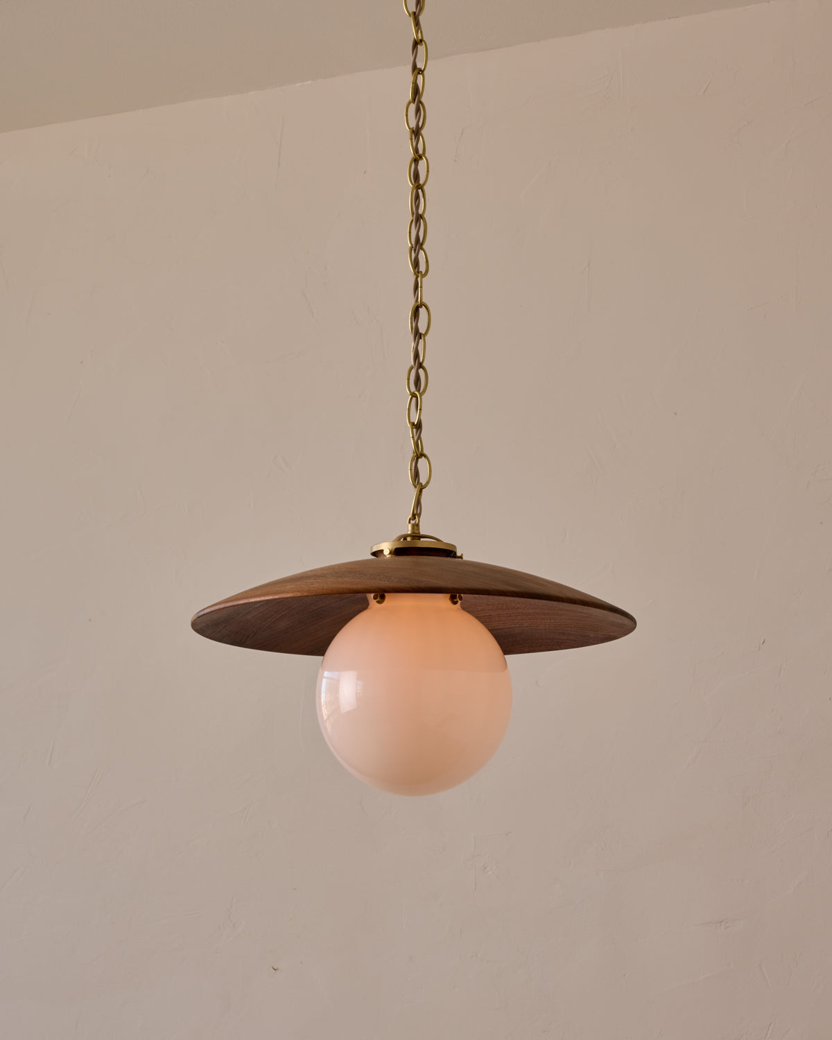 Large pendant light with oversized clear glass globe and decorative wooden clear maple shade with brass chain #shade-finish_black walnut #globe_white glass #cord-color_beige