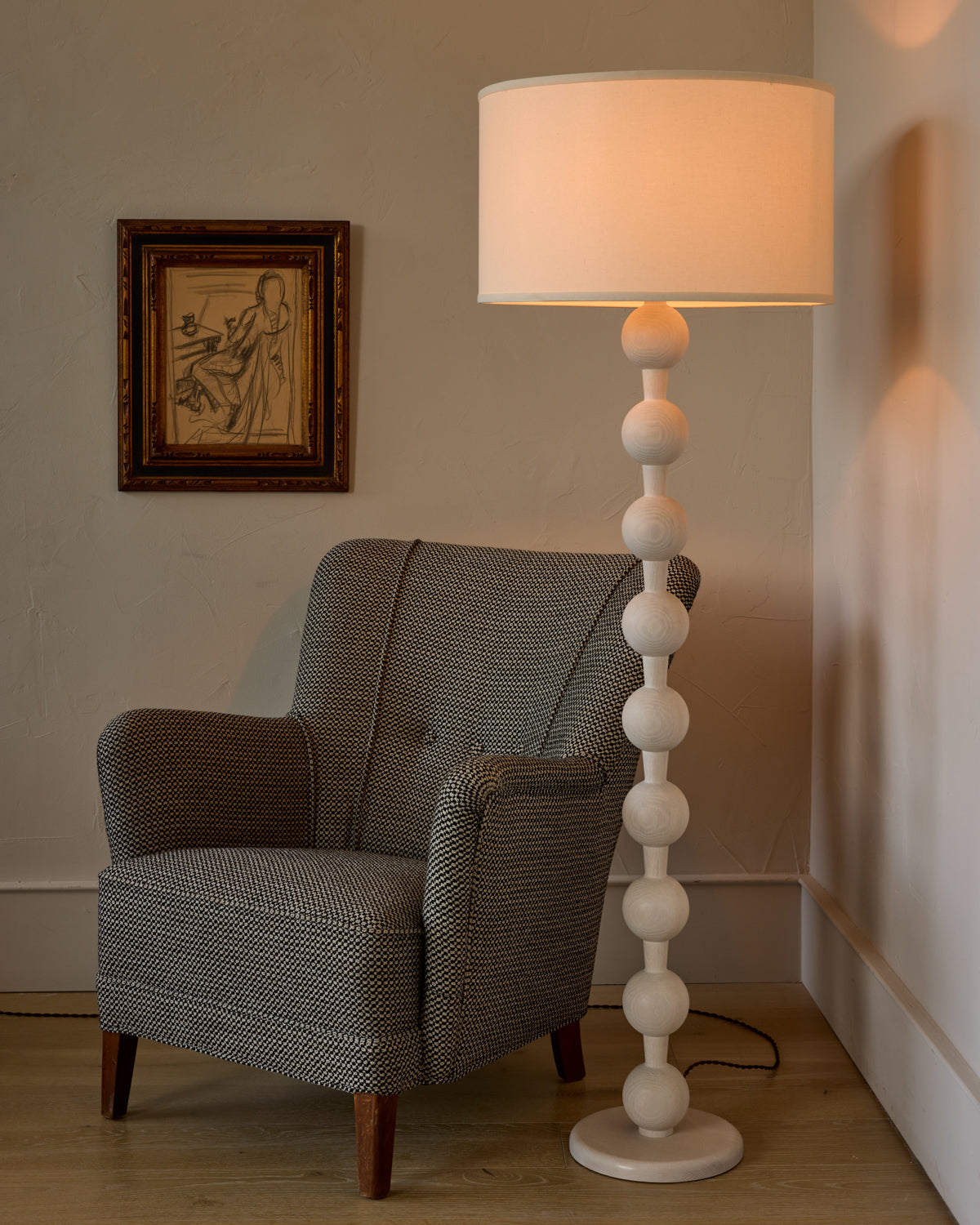 Tall sculptural solid red oak floor lamp with barbell design in white wash finish with ivory linen drum shade
#color_white wash red oak
#shade-color_ivory linen