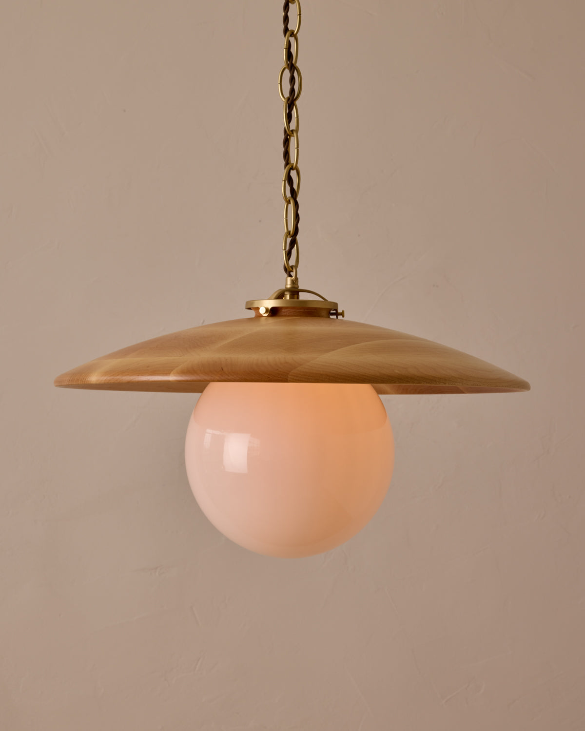 Large pendant light with oversized clear glass globe and decorative wooden clear maple shade with brass chain #shade-finish_natural maple #globe_white glass #cord-color_brown
