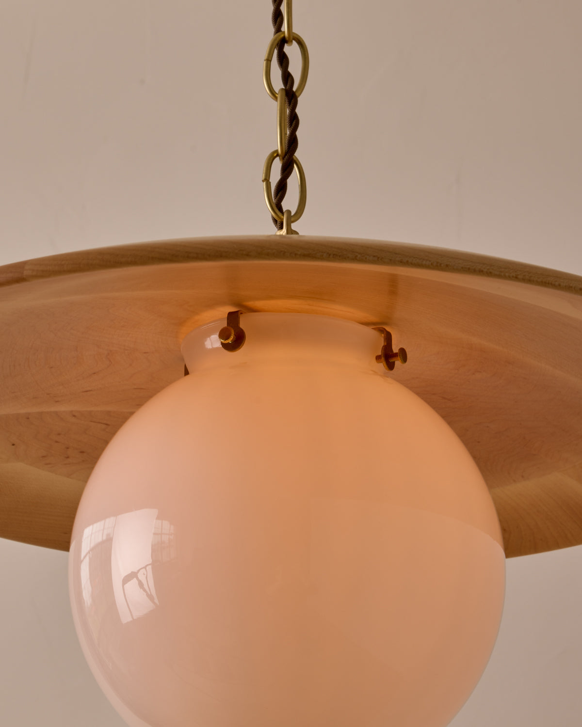 Large pendant light with oversized clear glass globe and decorative wooden clear maple shade with brass chain #shade-finish_natural maple #globe_white glass #cord-color_brown