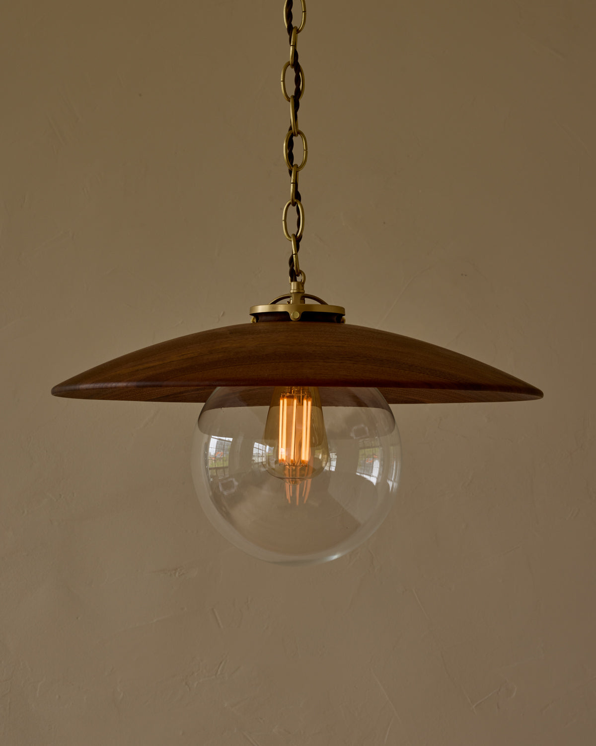Large pendant light with oversized clear glass globe and decorative wooden clear maple shade with brass chain #shade-finish_black walnut #globe_clear glass #cord-color_brown