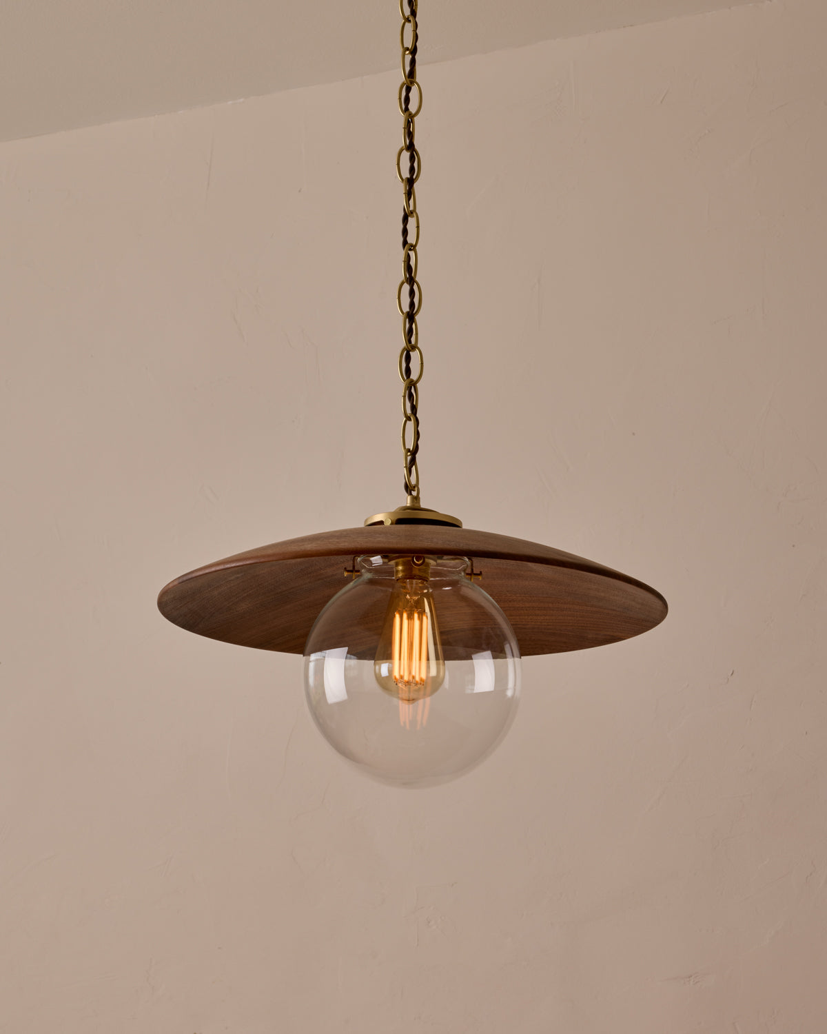 Large pendant light with oversized clear glass globe and decorative wooden clear maple shade with brass chain #shade-finish_black walnut #globe_clear glass #cord-color_brown
