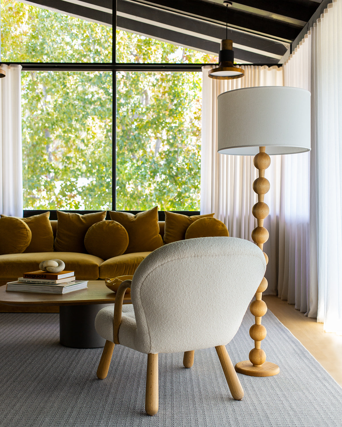 Tall sculptural solid red oak floor lamp with barbell design in natural finish with ivory linen drum shade, best seller, made in the USA
#color_natural red oak
#shade-color_ivory linen