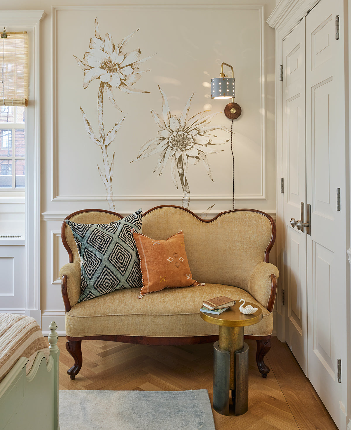 Articulating satin brass sconce with blue handstitched shade and walnut backplate in sitting room #leather-finish_cloud blue #wiring_plug-in