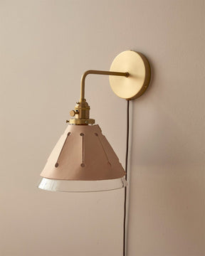 Classic satin brass plug in wall sconce with cone glass diffuser and decorative handstitched leather shade