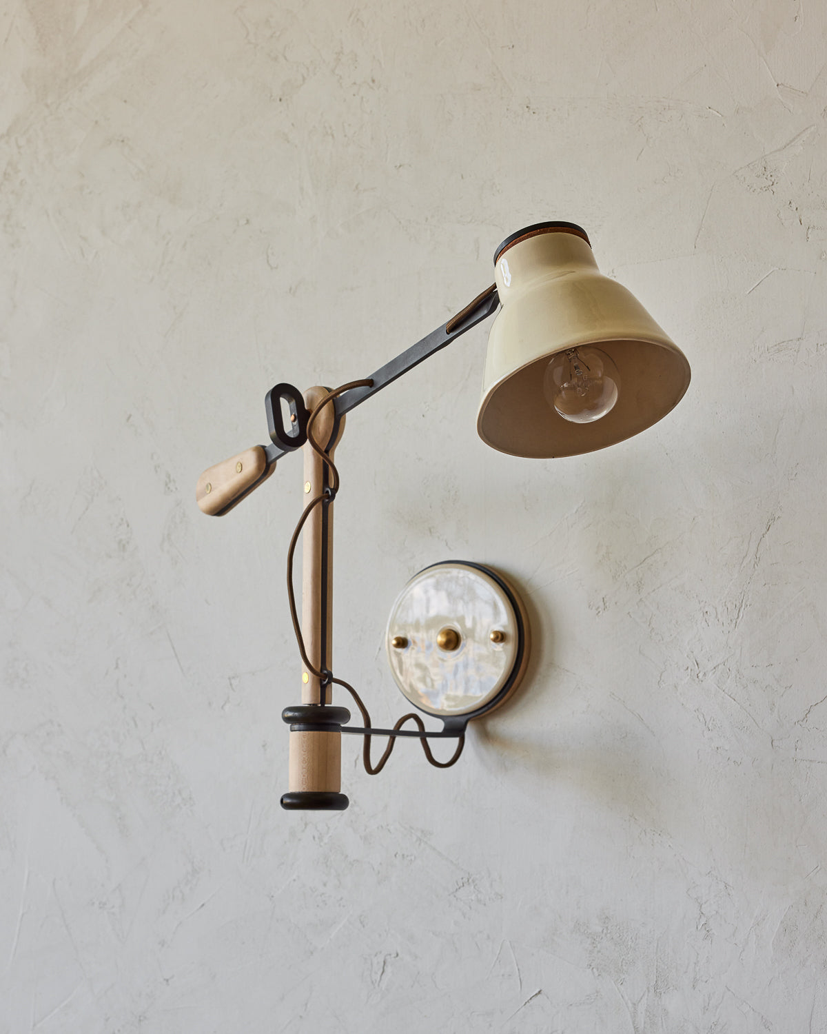 Maple, steel and ceramic wall sconce with articulating arm with glossy white stoneware shade and backplate #color_cream