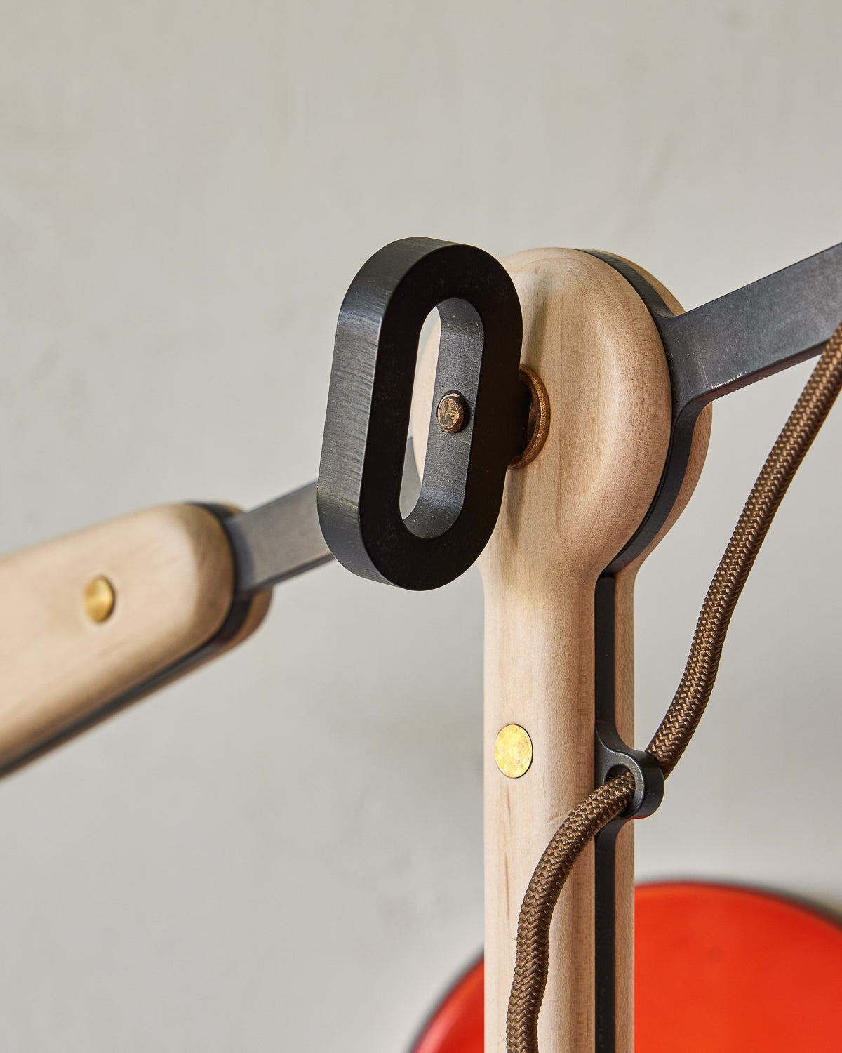 Maple, steel and ceramic wall sconce with articulating arm with glossy red orange stoneware shade and backplate #color_poppy