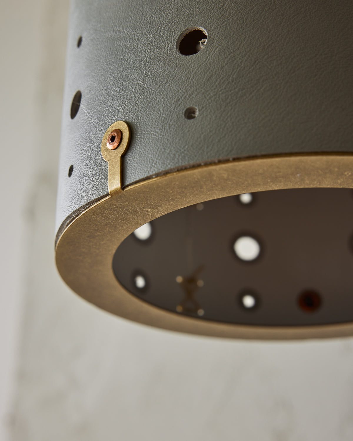 Articulating satin brass sconce with blue handstitched leather shade and walnut backplate