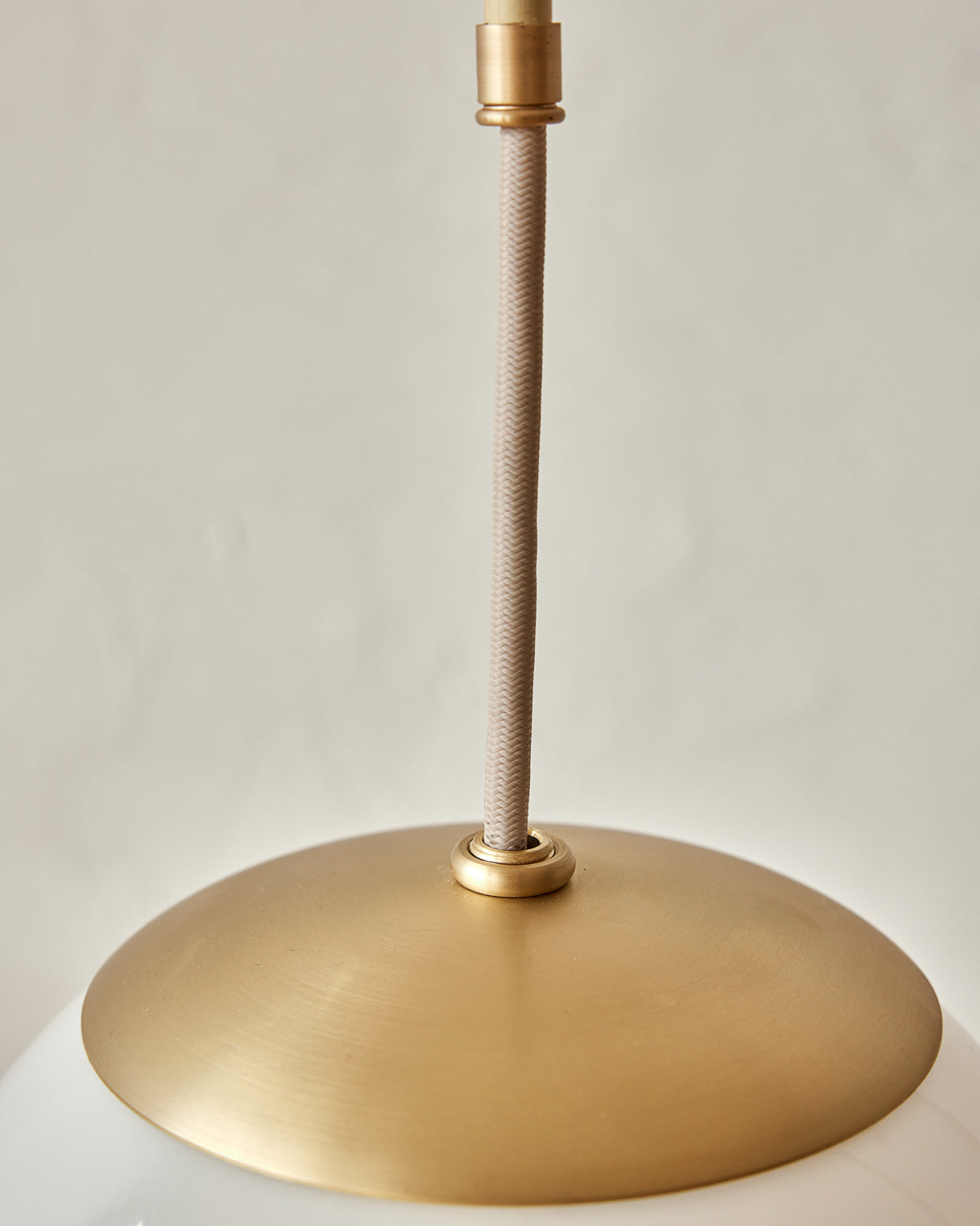 Modern brass globe pendant light with warm satin brass curved body and white milk glass globe #metal-finish_satin brass