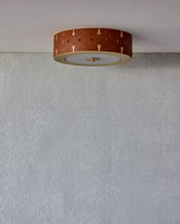 Beautiful satin brass flush mount ceiling fixture with handstitched leather drum shade #leather-color_tan harness