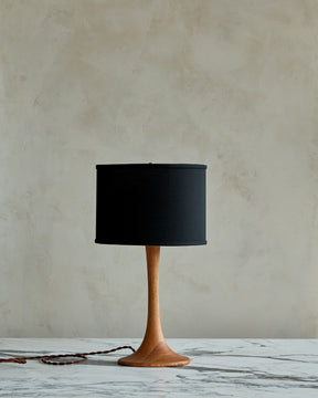 Small Trumpet table lamp with natural finish and black drum shade