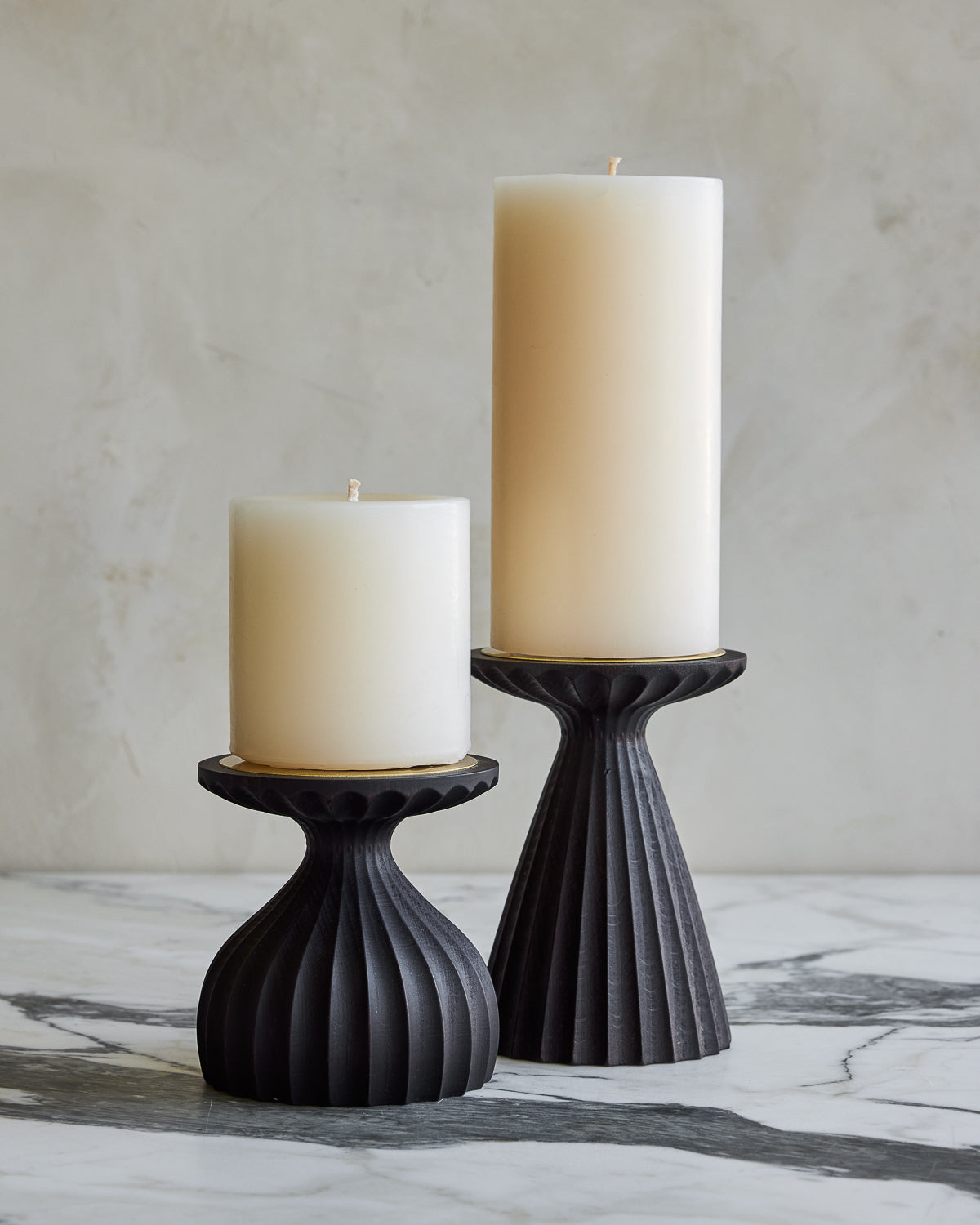 Pair of delicately grooved pillar candle holders in dark wash maple wood with shell white pillar candles