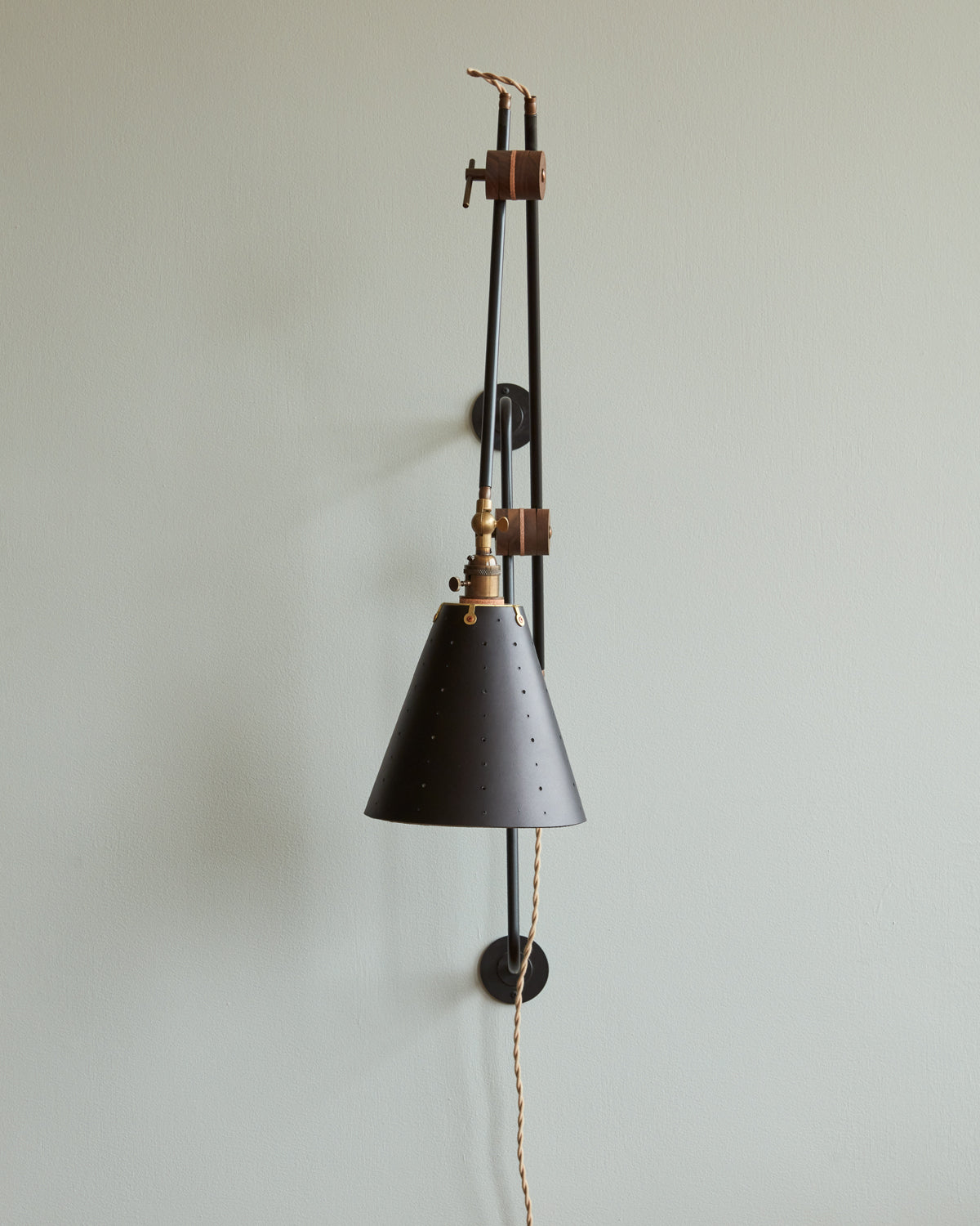 Large articulating black plug in wall sconce with black handstitched cone leather shade