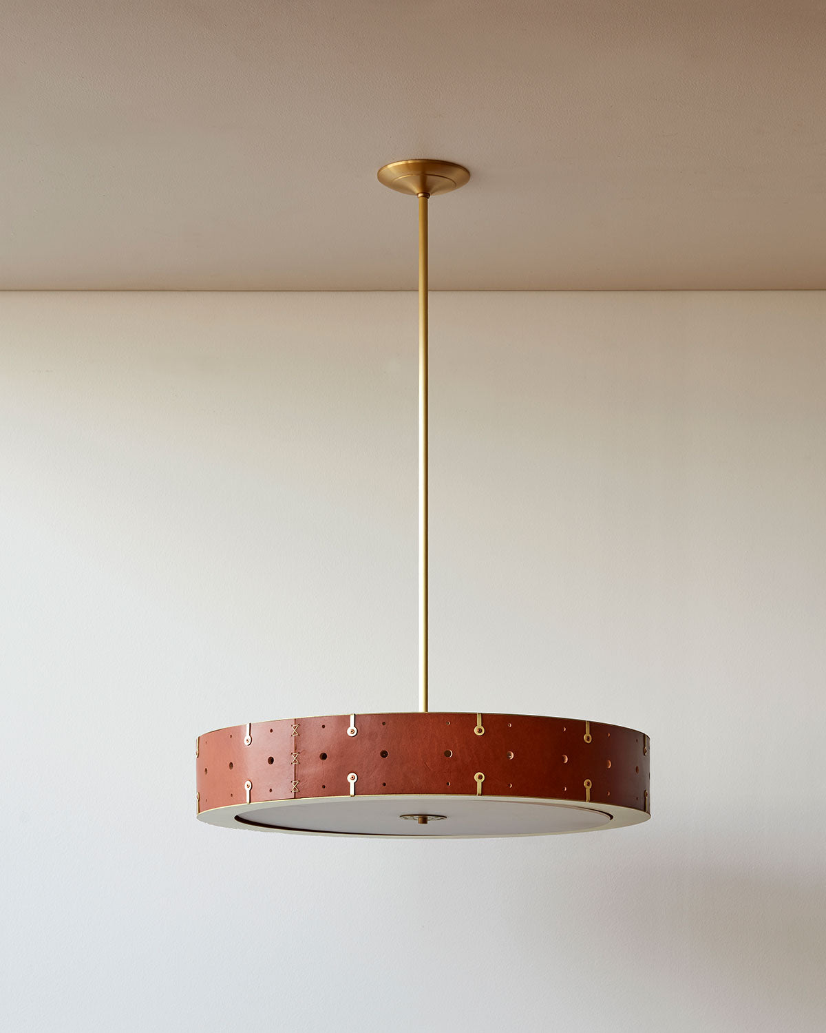 Beautiful satin brass ceiling pendant fixture with handstitched leather drum shade and customizable drop
#leather-color_tan harness #size_24" drum