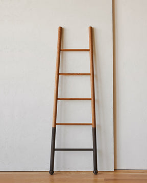 Reclaimed white oak oxidized decorative ladder from Lostine. Simple interior design, made in the USA. Warm American Modern Design