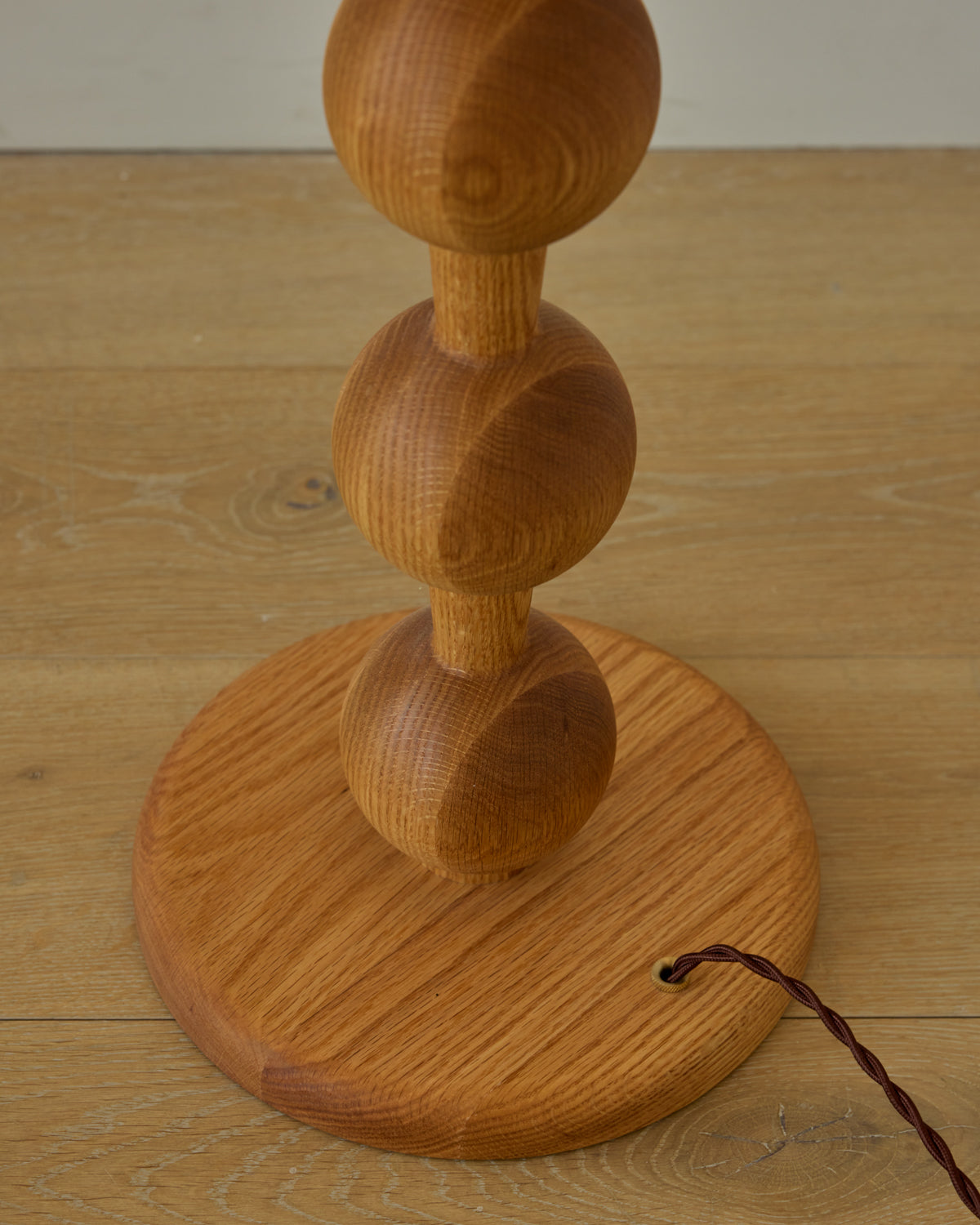 Tall sculptural solid red oak floor lamp with barbell design in natural finish with ivory linen drum shade, best seller, made in the USA 
#color_natural red oak