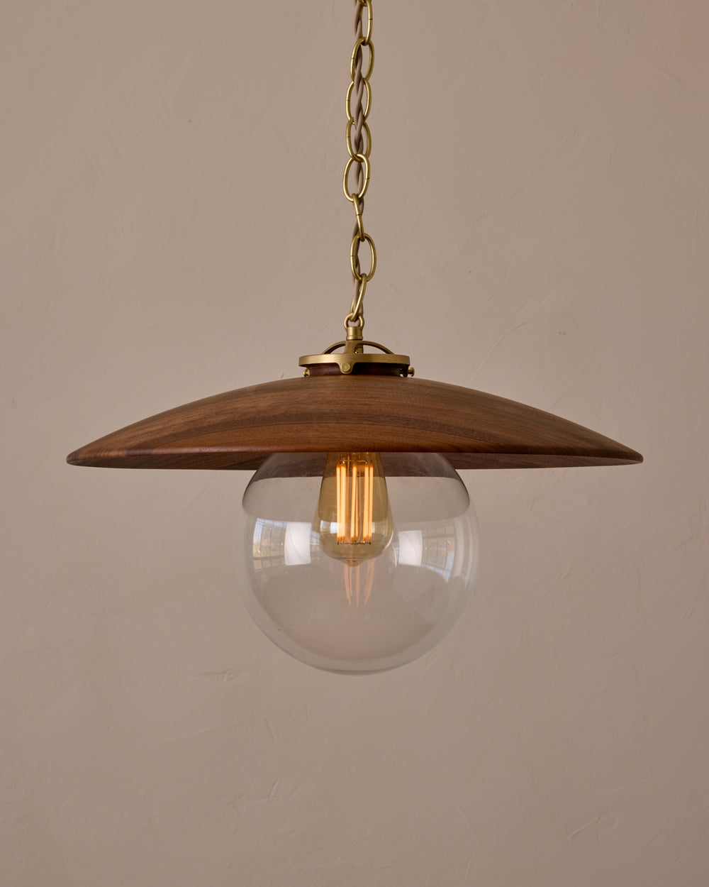 Large pendant light with oversized clear glass globe and decorative wooden clear maple shade with brass chain  #shade-finish_black walnut #globe_clear glass #cord-color_beige