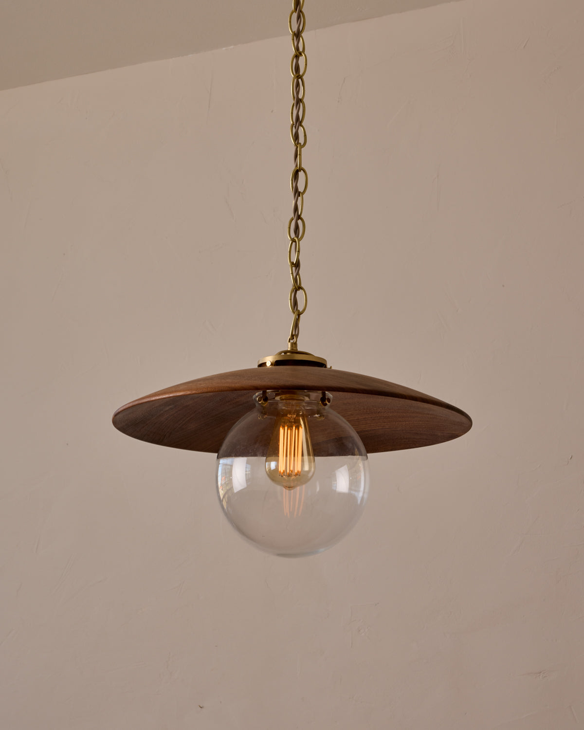 Large pendant light with oversized clear glass globe and decorative wooden clear maple shade with brass chain  #shade-finish_black walnut #globe_clear glass #cord-color_beige