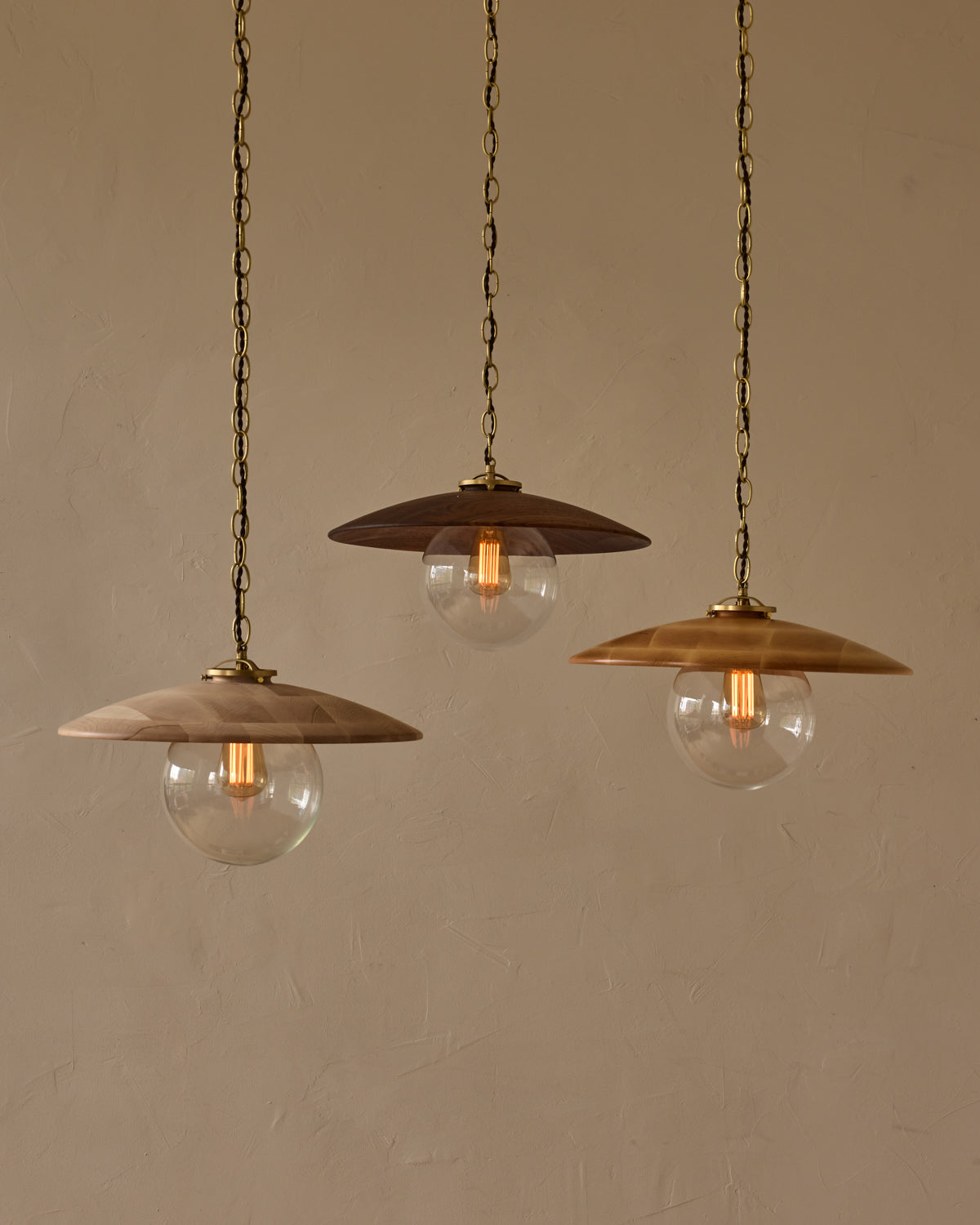 Large pendant light with oversized clear glass globe and decorative wooden clear maple shade with brass chain #shade-finish_clear maple #globe_clear glass #cord-color_brown