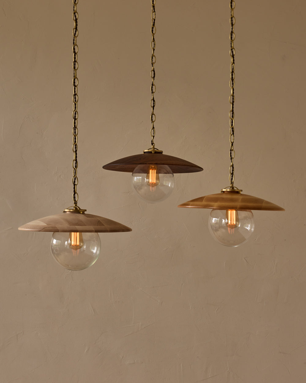 Large pendant light with oversized clear glass globe and decorative wooden clear maple shade with brass chain  #shade-finish_natural maple #globe_clear glass #cord-color_brown