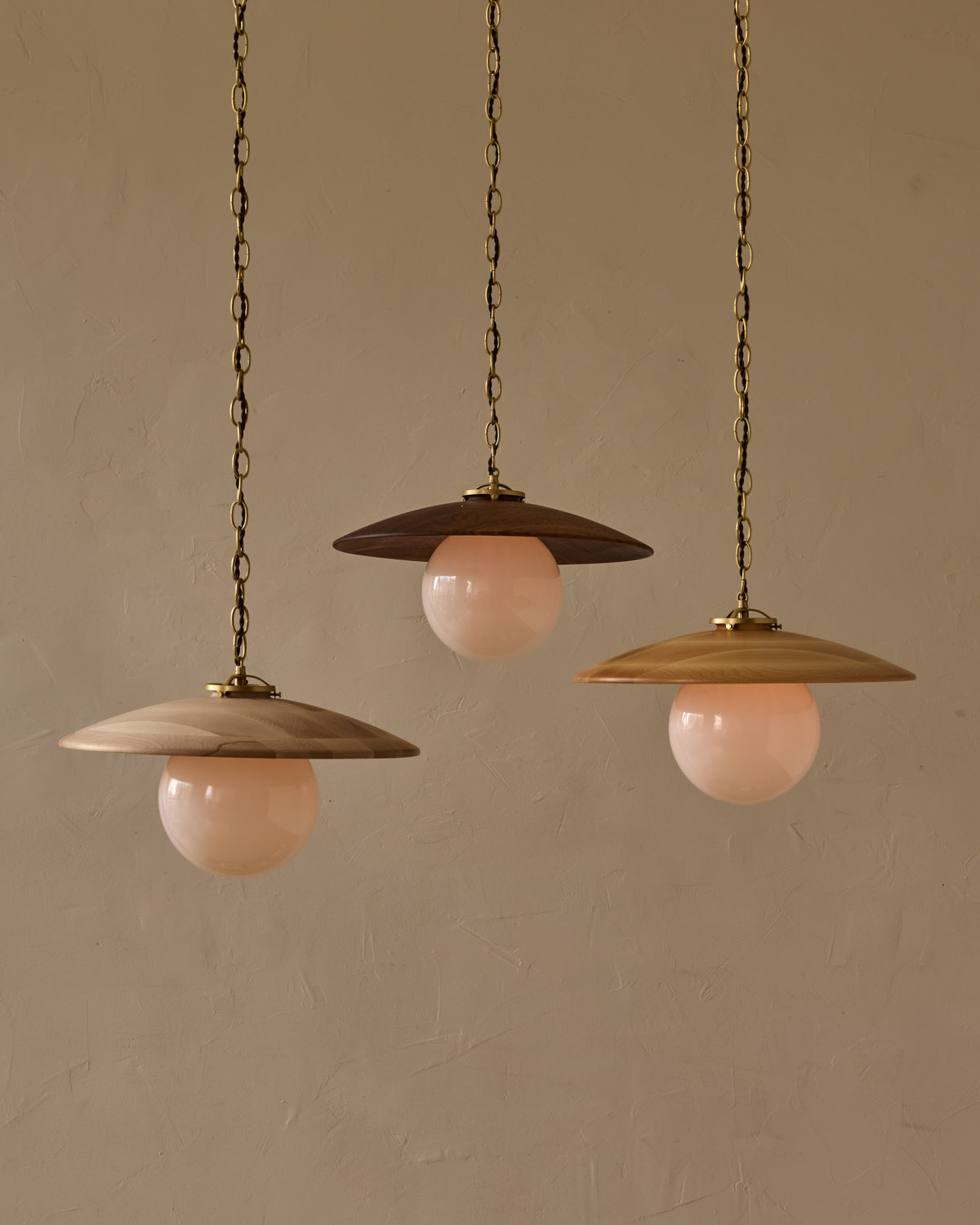 Large pendant light with oversized clear glass globe and decorative wooden clear maple shade with brass chain  #shade-finish_natural maple #globe_white glass #cord-color_brown