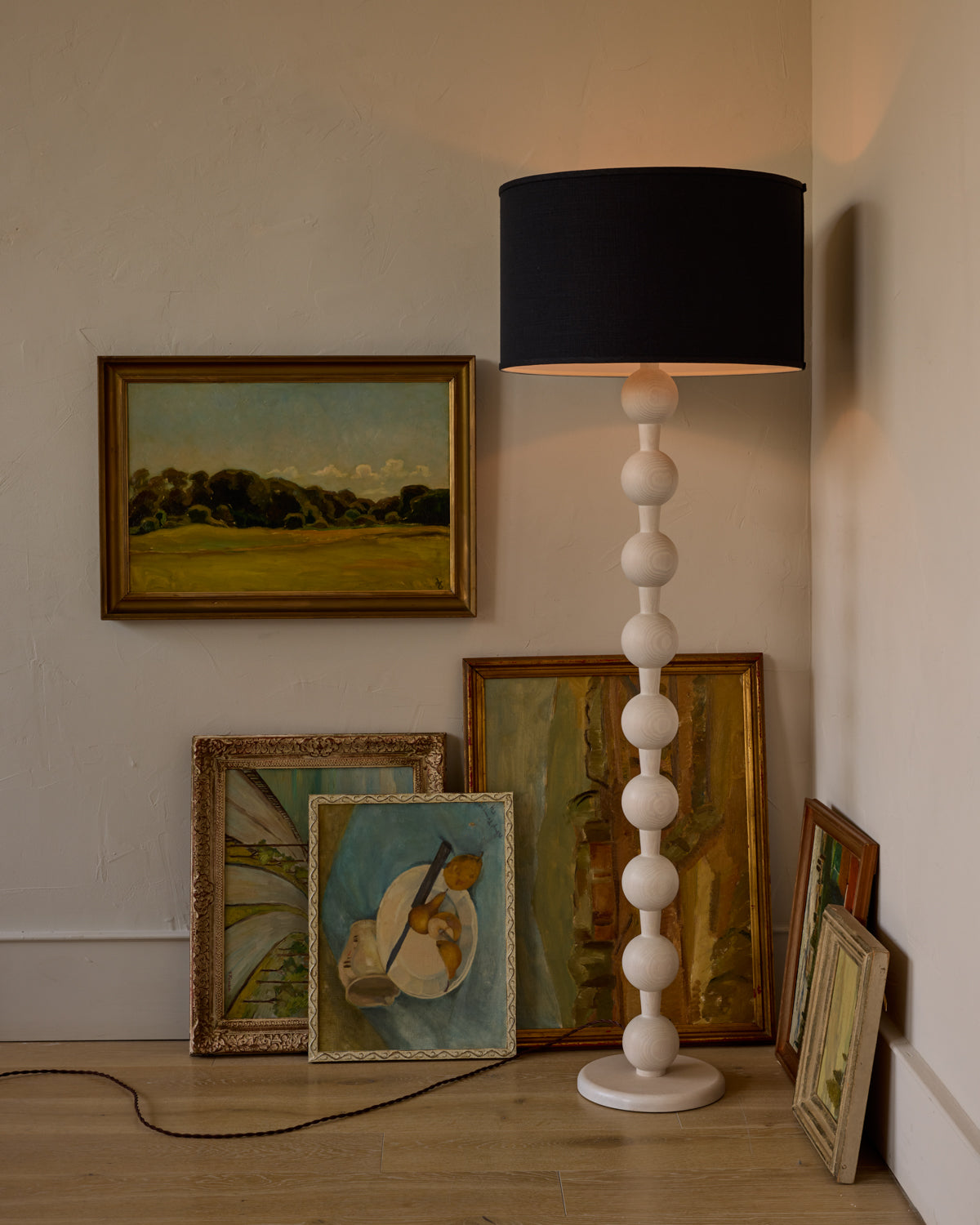 Tall sculptural solid red oak floor lamp with barbell design in white wash finish with ivory linen drum shade
#color_white wash red oak
#shade-color_black linen