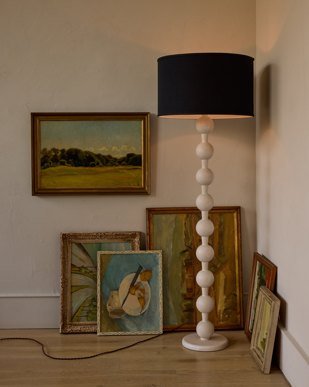 Tall sculptural solid red oak floor lamp with barbell design in white wash finish with ivory linen drum shade
#color_white wash red oak
#shade-color_black linen
