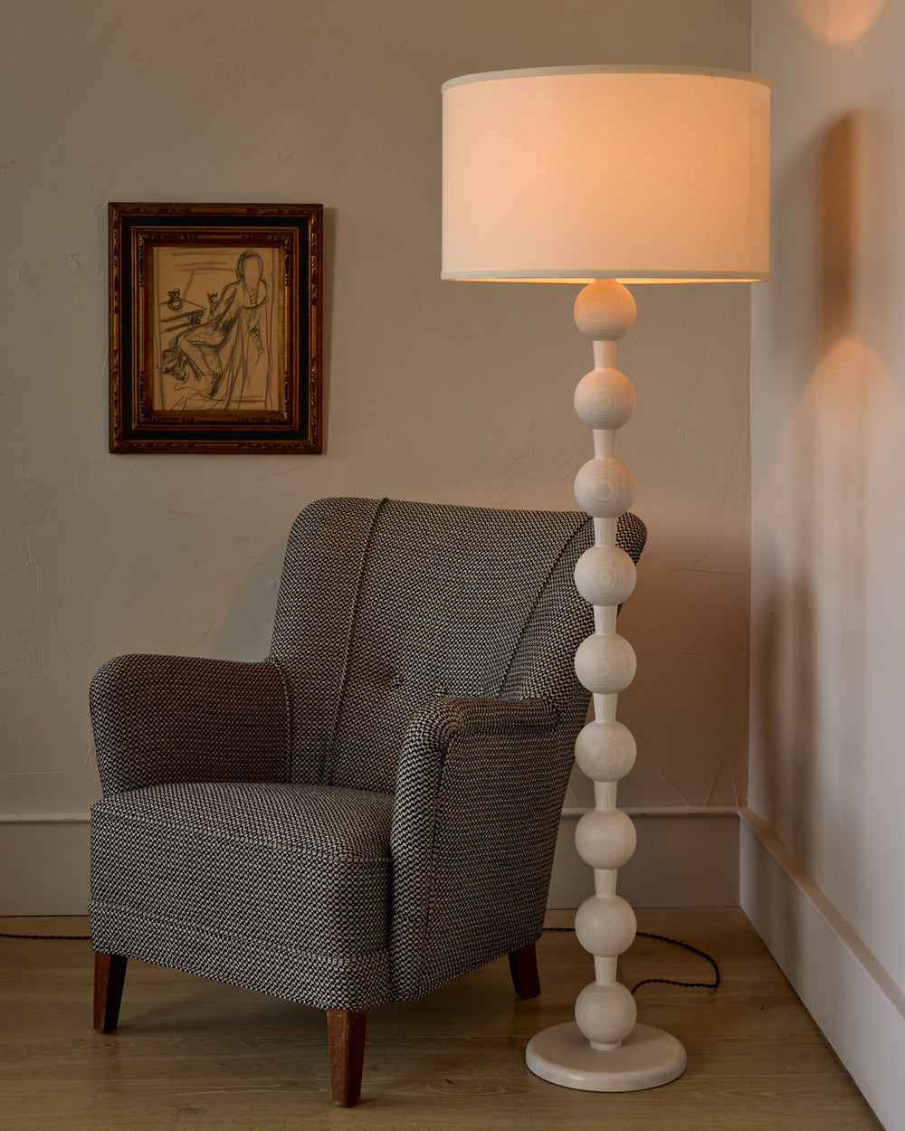 Tall sculptural solid red oak floor lamp with barbell design in white wash finish with ivory linen drum shade
#color_white wash red oak
#shade-color_ivory linen