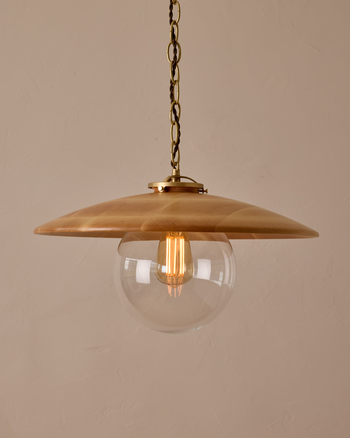 Large pendant light with oversized clear glass globe and decorative wooden clear maple shade with brass chain #shade-finish_natural maple