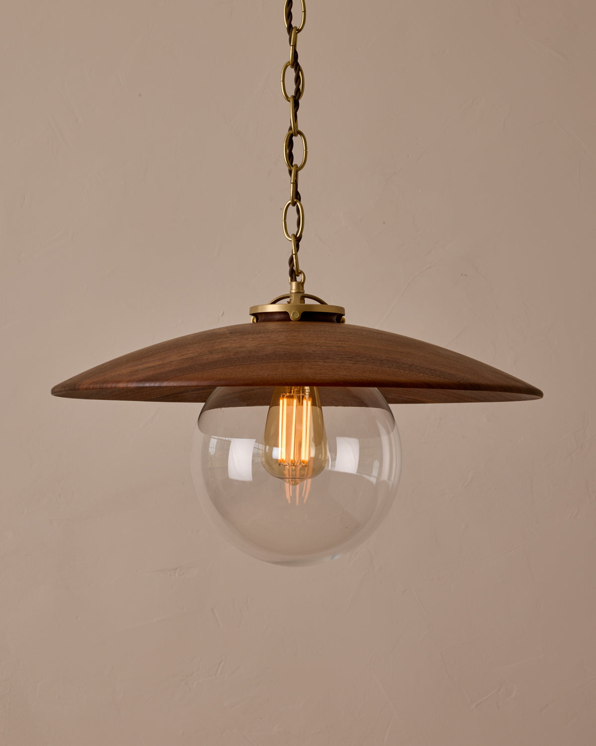 Large pendant light with oversized clear glass globe and decorative wooden clear maple shade with brass chain  #shade-finish_black walnut