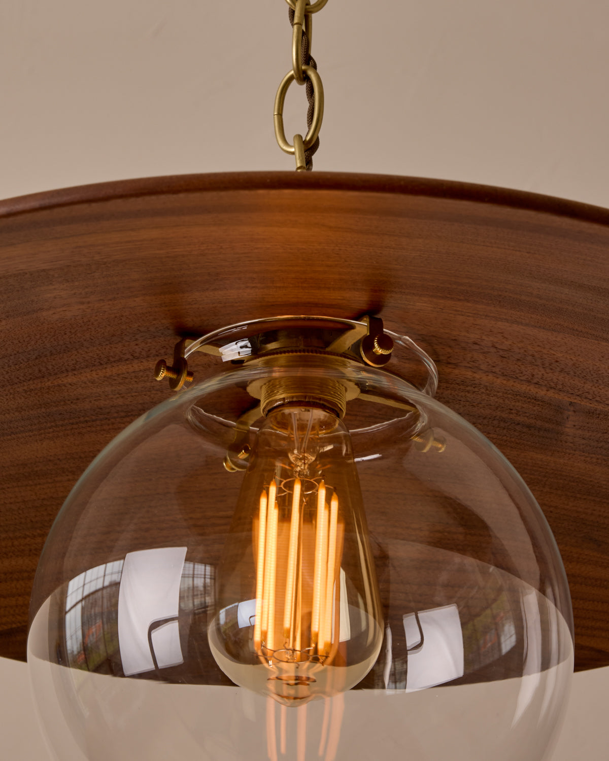 Large pendant light with oversized clear glass globe and decorative wooden clear maple shade with brass chain  #shade-finish_black walnut #globe_clear glass #cord-color_brown