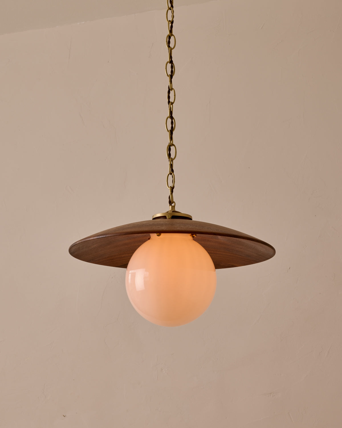 Large pendant light with oversized clear glass globe and decorative wooden clear maple shade with brass chain  #shade-finish_black walnut #globe_white glass #cord-color_brown