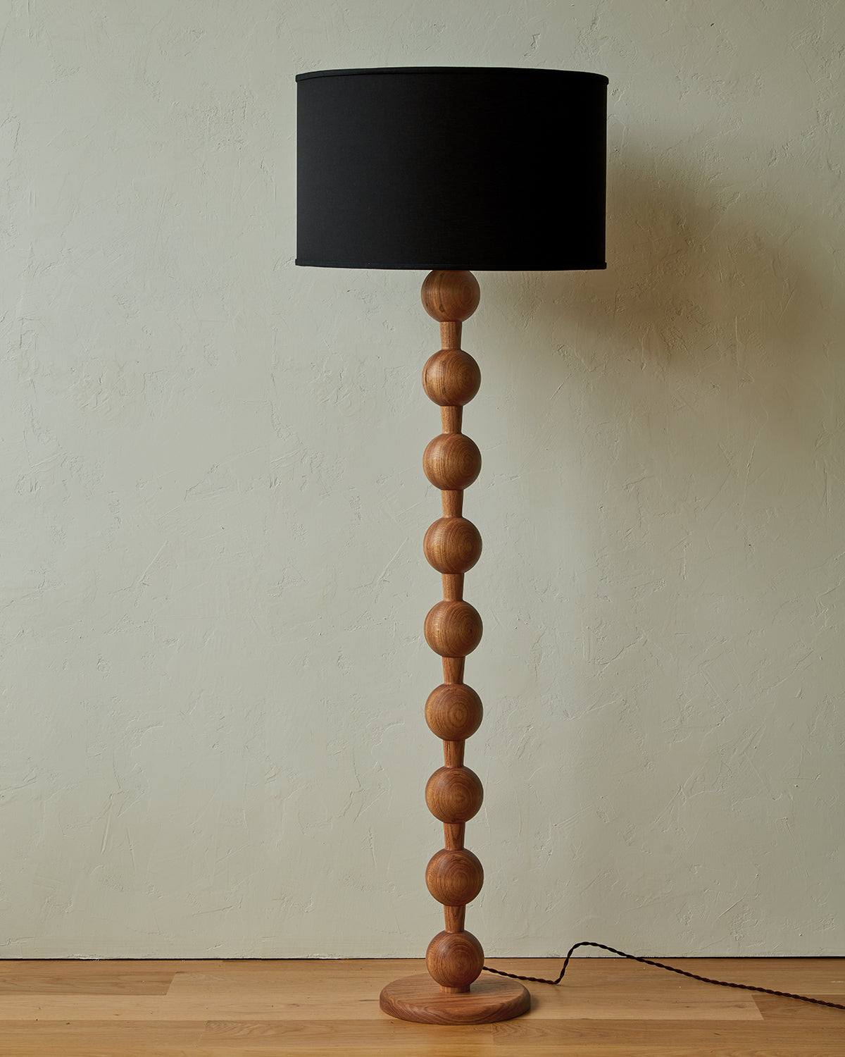 Tall sculptural solid red oak floor lamp with barbell design in natural finish with ivory linen drum shade, best seller, made in the USA 
#color_natural red oak
#shade-color_black linen