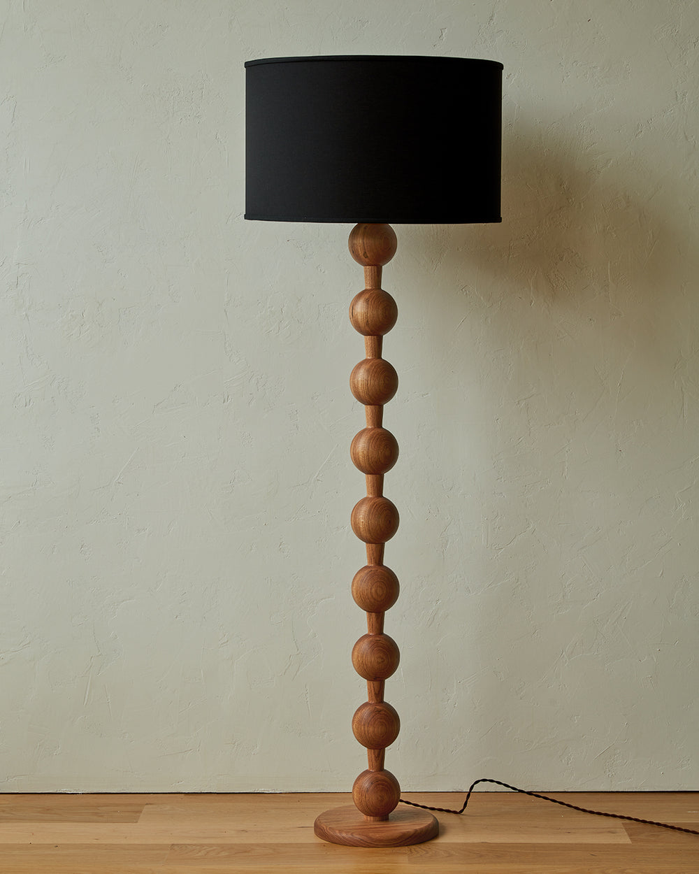 Tall sculptural solid red oak floor lamp with barbell design in natural finish with ivory linen drum shade, best seller, made in the USA 
#color_natural red oak
#shade-color_black linen