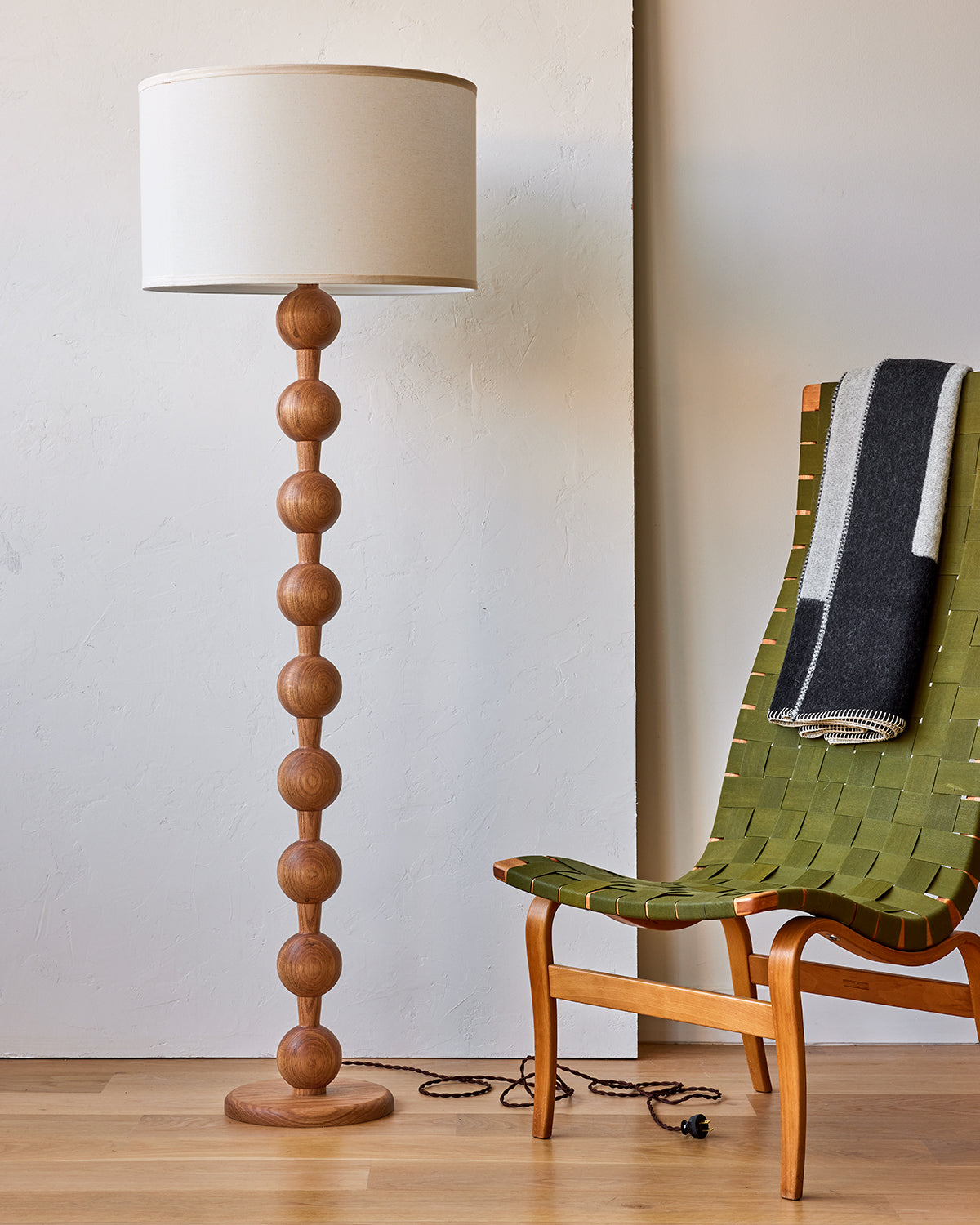 Tall sculptural solid red oak floor lamp with barbell design in natural finish with ivory linen drum shade, best seller, made in the USA 
#color_natural red oak
#shade-color_ivory linen