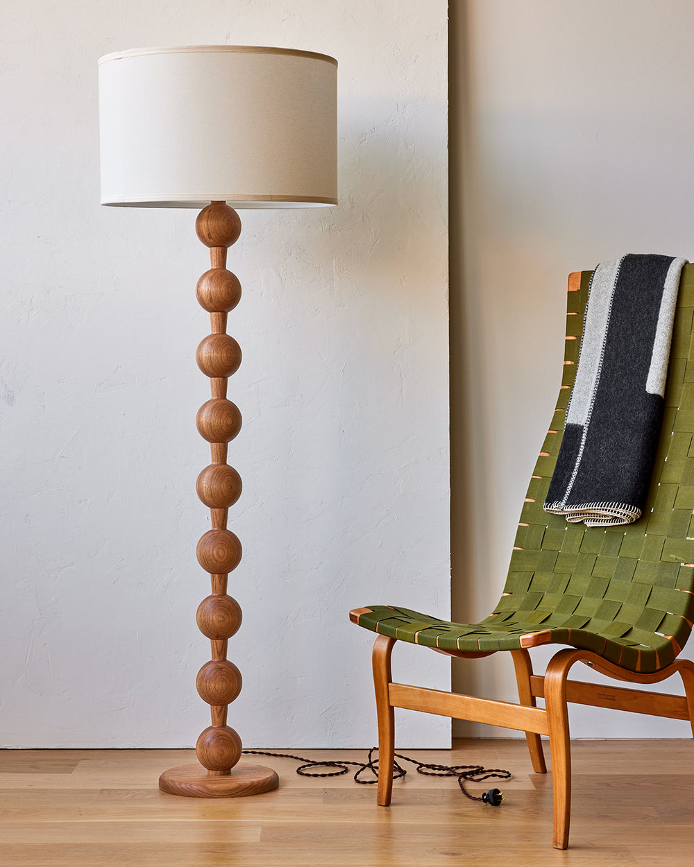 Tall sculptural solid red oak floor lamp with barbell design in natural finish with ivory linen drum shade, best seller, made in the USA 
#color_natural red oak
#shade-color_ivory linen