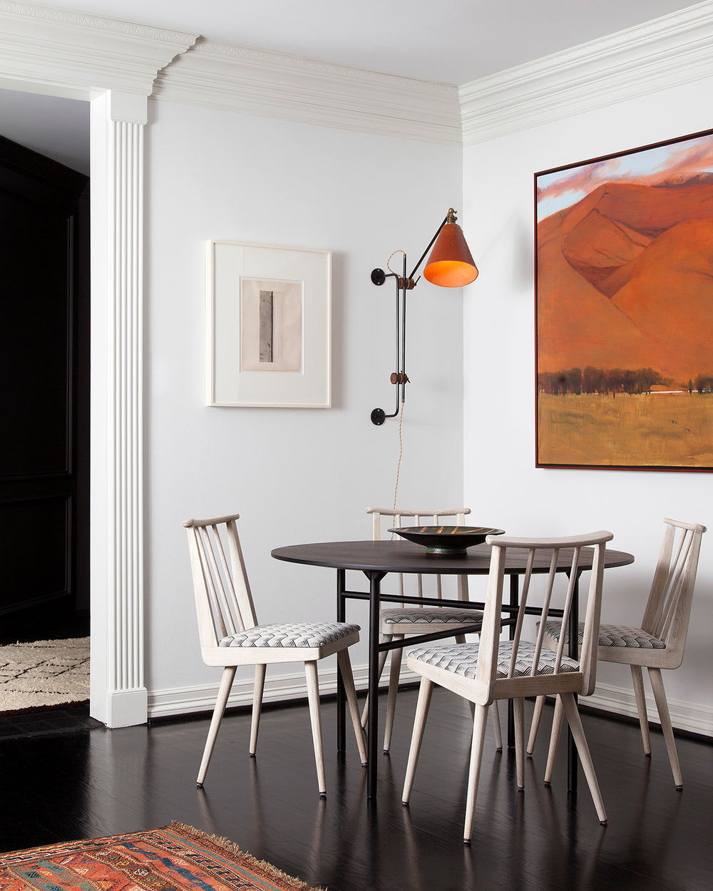 Large articulating black plug in wall sconce with tan handstitched cone leather shade in dining room #shade-finish_tan harness #wiring_plug-in