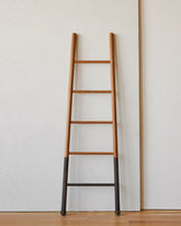 Reclaimed white oak oxidized decorative ladder from Lostine. Simple interior design, made in the USA. Warm American Modern Design