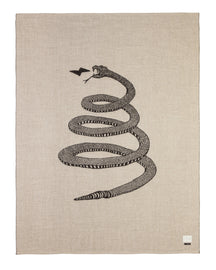 Soft baby alpaca reversible blanket with black and light tan loosely coiled rattlesnake pattern