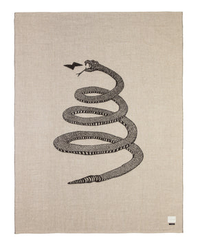 Soft baby alpaca reversible blanket with black and light tan loosely coiled rattlesnake pattern