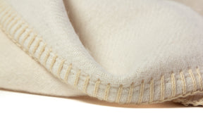 Soft baby alpaca reversible blanket with ivory and white rectangles and stitched edges