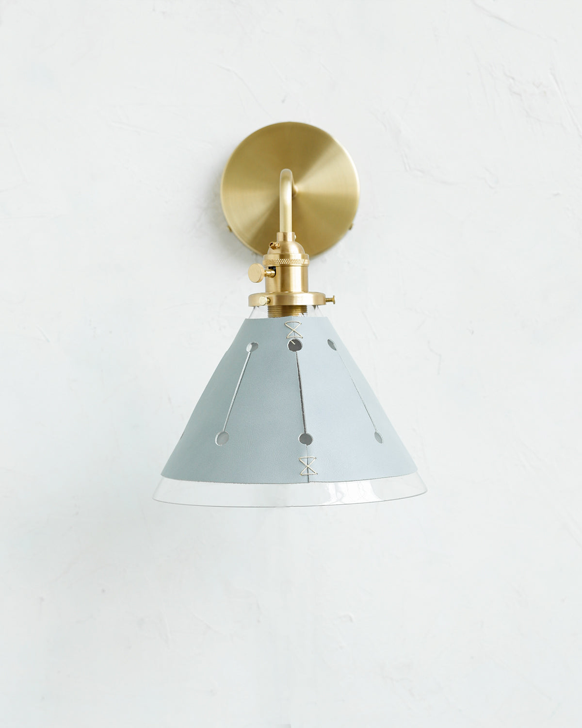 Classic hardwired satin brass wall sconce with cone glass diffuser and decorative handstitched leather shade