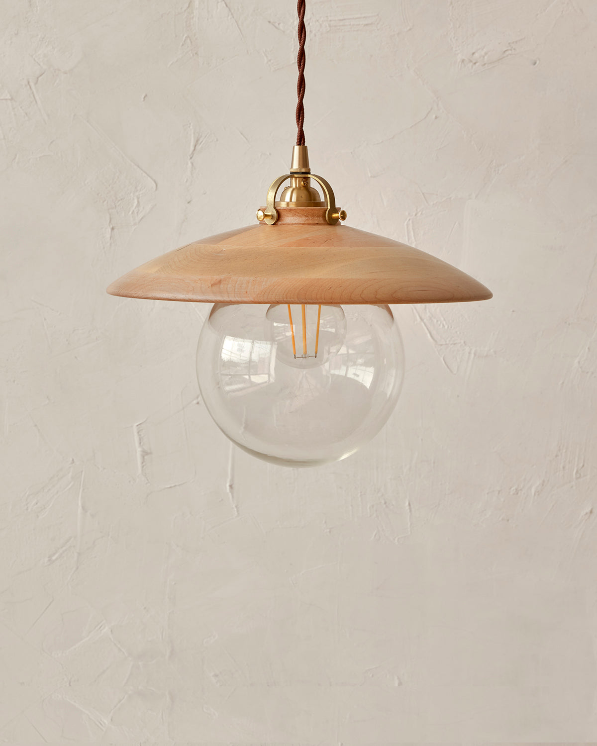 Pendant light with large clear glass globe and decorative wooden natural maple shade