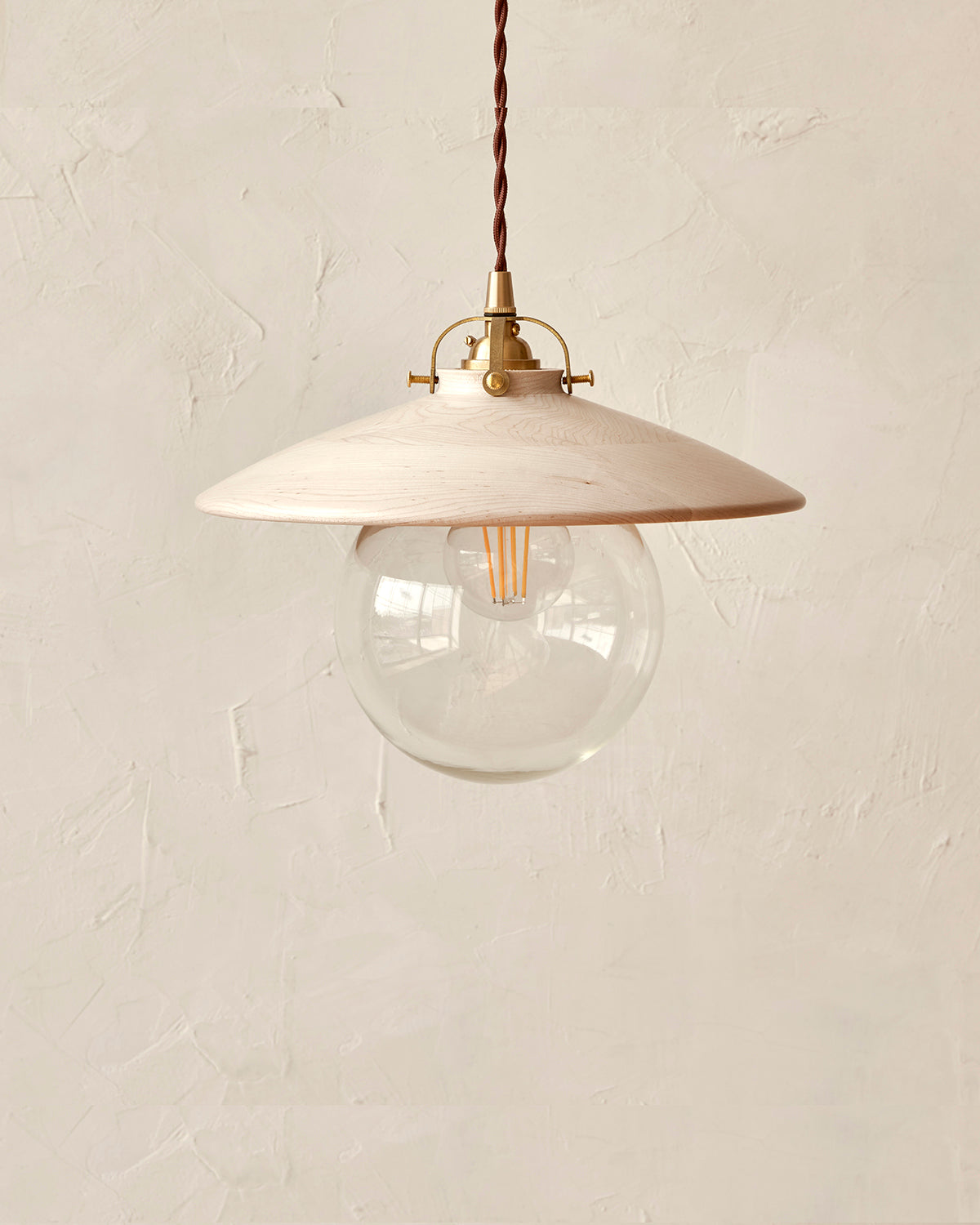 Pendant light with large clear glass globe and decorative wooden clear maple shade. Hardwired or plug light fixture. Made by Lostine in Philadelphia. Simple interior design, made in the USA. Warm American Modern Design