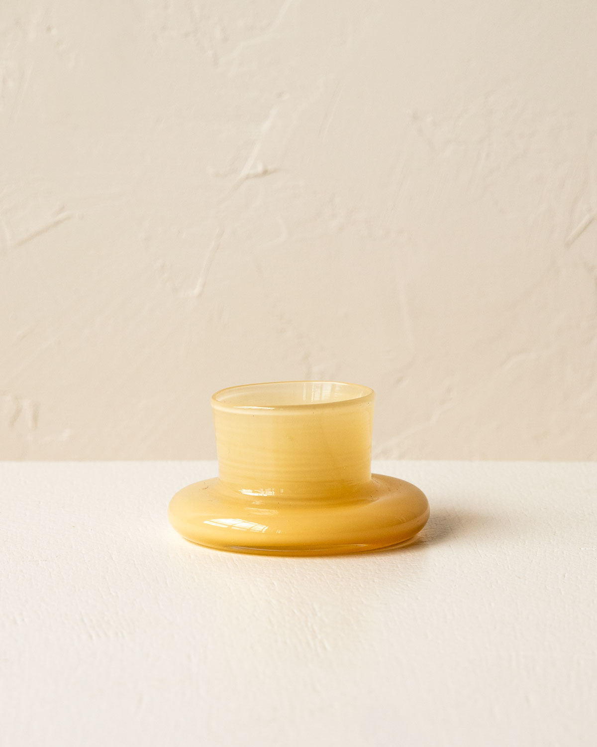 Handmade sandy yellow glass tea light holder
