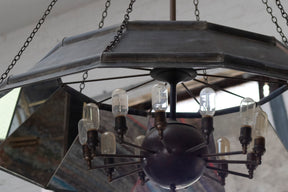 Victorian style metal chandelier with mirrored interior and Edison bulbs