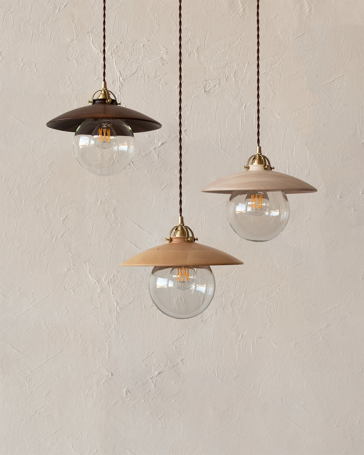 Pendant light with large clear glass globe and decorative wooden clear maple shade. Made by Lostine in Philadelphia. Simple interior design, made in the USA. Warm American Modern Design